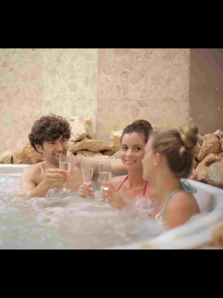 Three people in an inflatable hot tub.