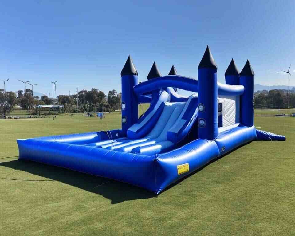 An inflatable slide tied down with ground stakes.